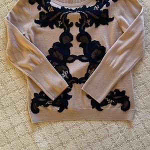 Stylish black and tan sweater with lace detailing.